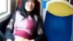 Asian milf rubs her clit on a train.